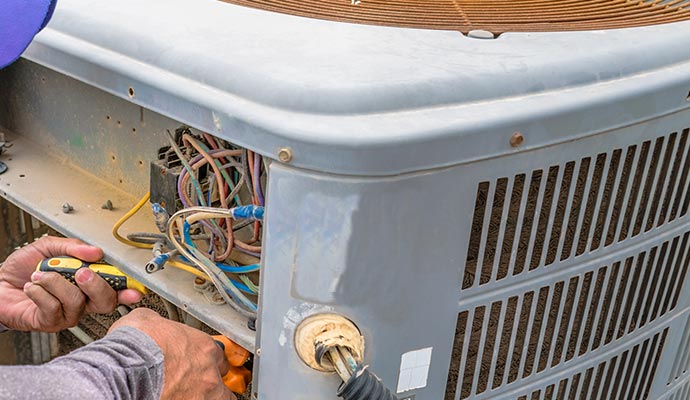 Professional worker fixing AC unit