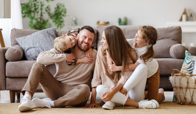 Happy family relaxing together living room enjoying comfortable indoor environment