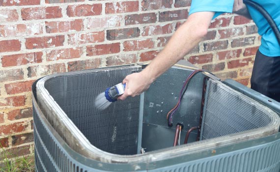 worker cleaning heating system