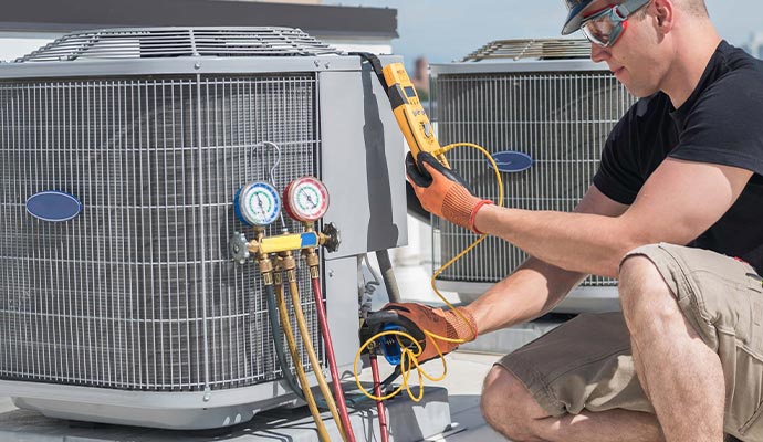 Worker providing heating tune-up services