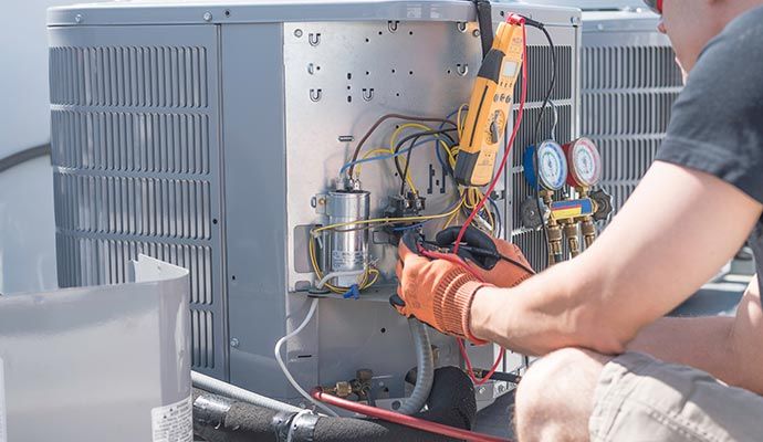 An expert repairing an air conditioning unit